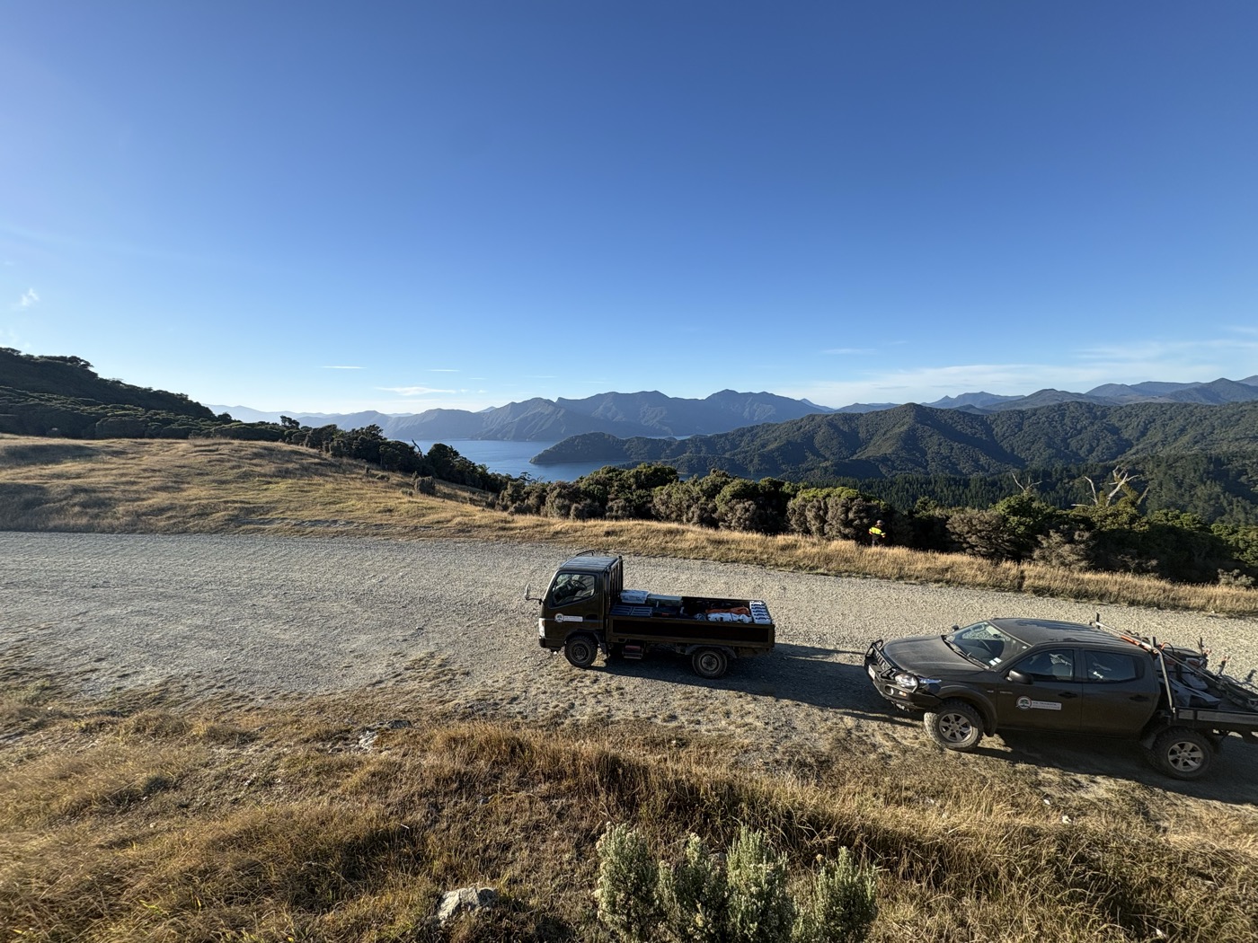 Vehicles on ridge above Marlborough Sounds